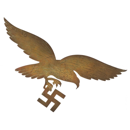 2490 - A German military interest brass eagle with Swastika plaque, 30cm wide