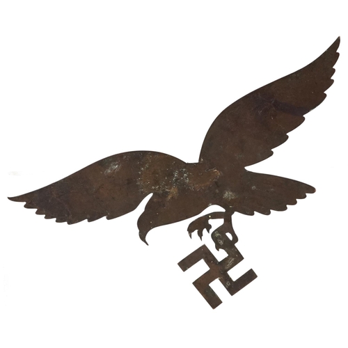 2490 - A German military interest brass eagle with Swastika plaque, 30cm wide