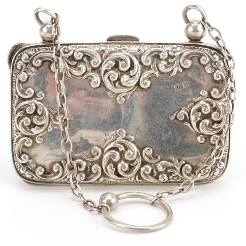 579 - An Edwardian embossed silver chatelaine purse and silver mounted leather chatelaine spectacle case h... 