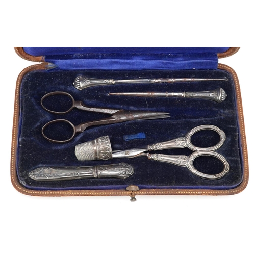 84 - A collection of Victorian and later manicure tools, some silver, housed in a velvet and silk lined f... 