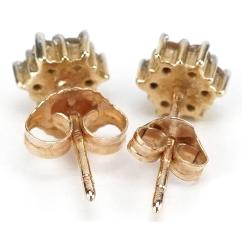 3136 - A pair of 9ct gold diamond flower head stud earrings, 6.3mm high, total 1.2g.