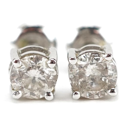 3046 - A pair of 9ct white gold diamond solitaire stud earrings, 4.26mm in diameter, total 0.9g.