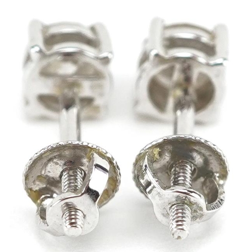 3046 - A pair of 9ct white gold diamond solitaire stud earrings, 4.26mm in diameter, total 0.9g.