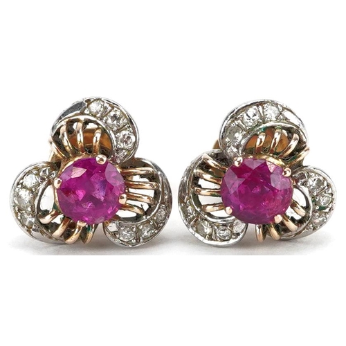 3040 - A pair of 18ct gold ruby and diamond stud earrings with screw on backs, 11.9mm high, total 4.6g.