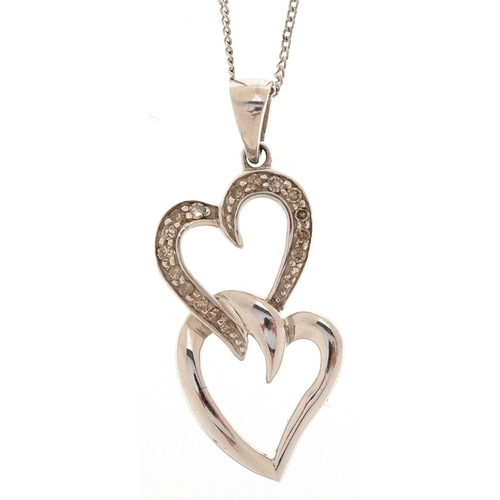 3182 - A 9ct white gold and diamond double love heart pendant on a 9ct white gold necklace, 28.7mm high, to... 