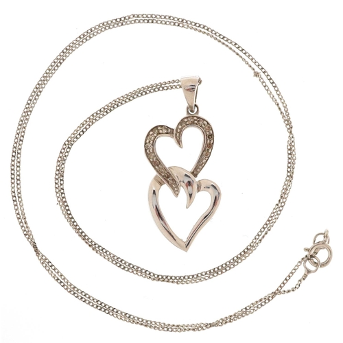 3182 - A 9ct white gold and diamond double love heart pendant on a 9ct white gold necklace, 28.7mm high, to... 