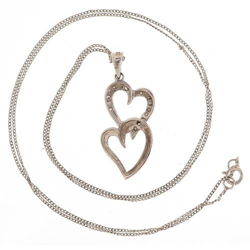 3182 - A 9ct white gold and diamond double love heart pendant on a 9ct white gold necklace, 28.7mm high, to... 