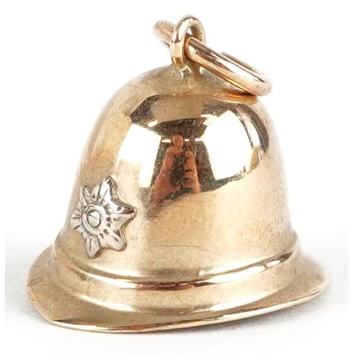 3653 - A 9ct gold charm in the form of a Police helmet, 14.8mm wide, 1.2g.