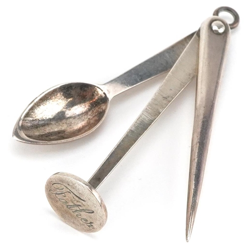 A sterling silver folding pipe tamper with tobacco spoon and pipe cleaner, 6cm in length when folded, 13.0g.