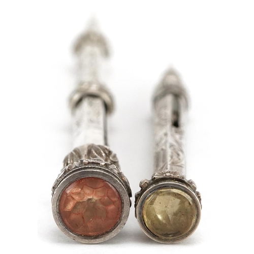 267 - Two Edwardian unmarked silver propelling pencils with citrine terminals, the largest 9.5cm in length... 