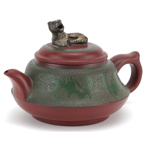 371 - A Chinese Yixing stoneware teapot, early 20th century, with a green glaze finish, bearing circular c... 