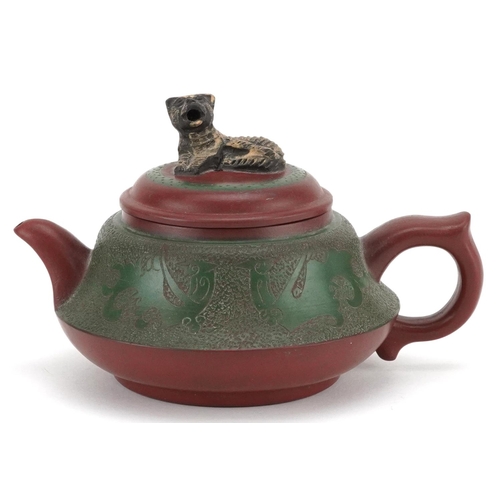  A Chinese Yixing stoneware teapot, early 20th century, with a green glaze finish, bearing circular c... 