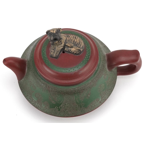 371 - A Chinese Yixing stoneware teapot, early 20th century, with a green glaze finish, bearing circular c... 