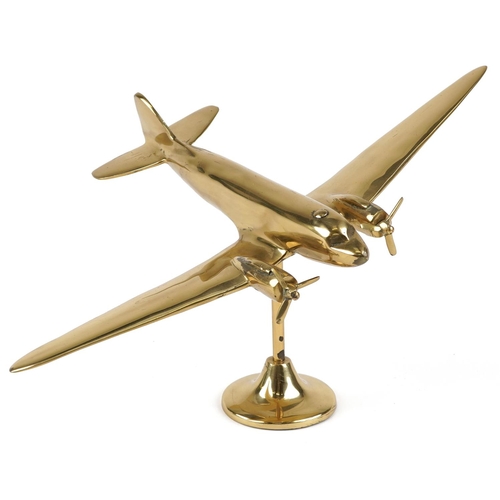 2457 - An early 20th century polished brass desk stand of a twin propeller aeroplane on a circular plinth b... 