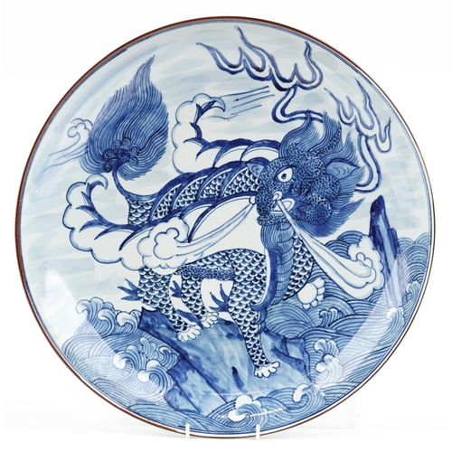 369 - A Chinese blue and white porcelain circular charger, 20th century, decorated with a dragon, baring s... 