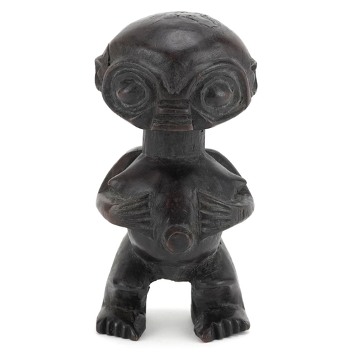 199 - An African squat figure standing four square, probably Kuba, 20th century, dark polished brown patin... 