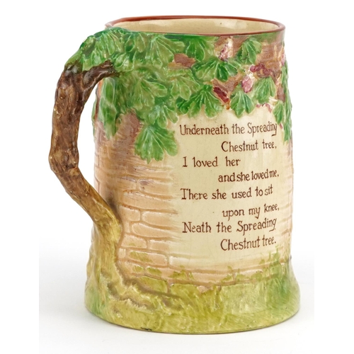 282 - A Crown Devon musical tankard, circa 1930, moulded and coloured in relief with lovers outside a forg... 