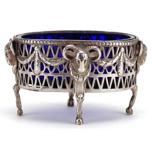 504 - An early 20th century silver open table salt cast with rams heads and swags, raised on four hoof fee... 