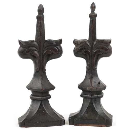 317 - A pair of 17th century style carved oak finials, 30cm high, 20cm wide.