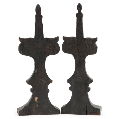 317 - A pair of 17th century style carved oak finials, 30cm high, 20cm wide.