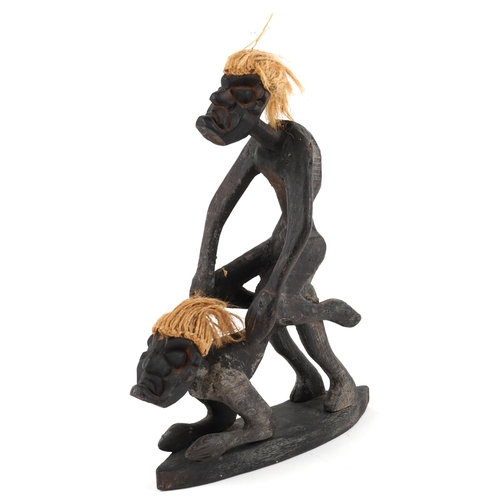 201 - A late 20th century African erotic carving, the two male figures, copulating with coir woven hair on... 