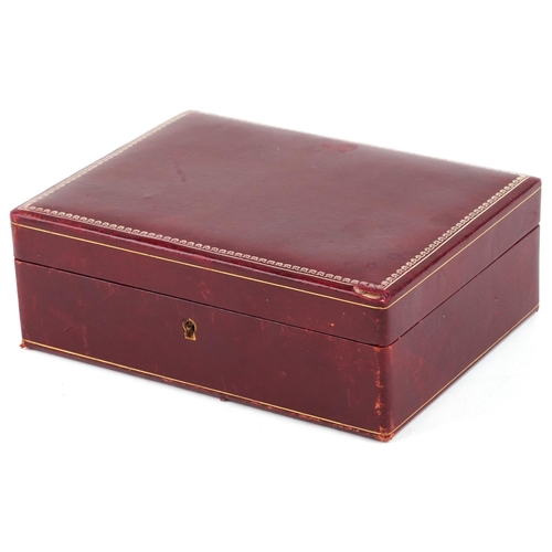 3816 - An early 20th century red leather jewellery box with silvered and gilt tooled decoration, 24cm wide.