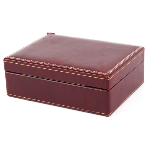 3816 - An early 20th century red leather jewellery box with silvered and gilt tooled decoration, 24cm wide.