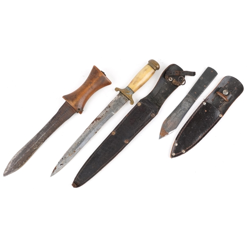 2525 - Three military interest daggers, one with horn handle and leather sheath, the largest 32cm in length... 