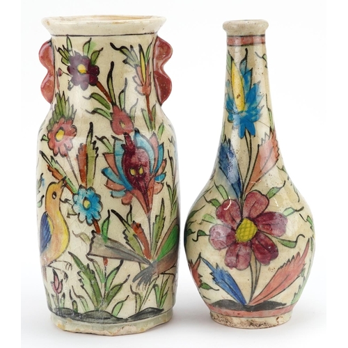 358 - Two early 20th century Iranian pottery vases, each decorated with birds amongst flowers, the largest... 