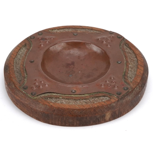 335 - An Arts & Crafts Newlyn School copper & oak pin tray, diameter 15cm.