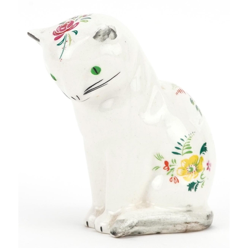 66 - A Plichta creamware model of a cat, the seated cat painted with sprigs of flowers, green eyes marked... 