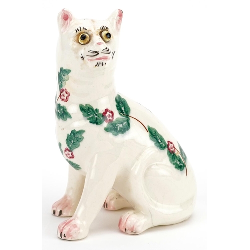 65 - A greamware Galle style cat, circa 1920, Bovey Tracey, the body decorated with sprigs of foliage and... 