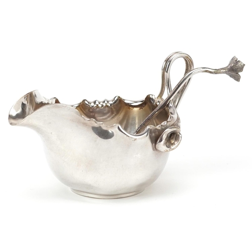 1214 - A Dixon & Co. plated Art Nouveau cream jug & sifter spoon, with frilly border and handle formed from... 