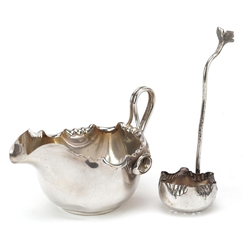 1214 - A Dixon & Co. plated Art Nouveau cream jug & sifter spoon, with frilly border and handle formed from... 