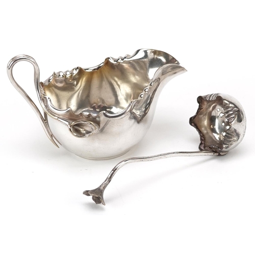 1214 - A Dixon & Co. plated Art Nouveau cream jug & sifter spoon, with frilly border and handle formed from... 