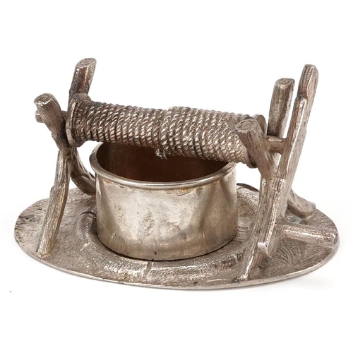 381 - A novelty plated knife rests in the form of a well, circa 1880, on a naturalistic oval base, W-8cm.