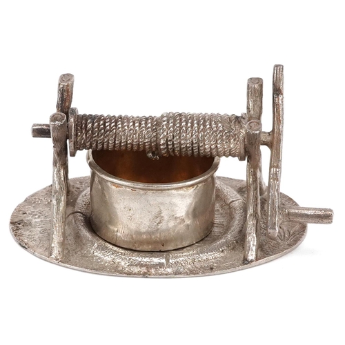 381 - A novelty plated knife rests in the form of a well, circa 1880, on a naturalistic oval base, W-8cm.