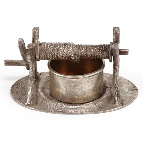 381 - A novelty plated knife rests in the form of a well, circa 1880, on a naturalistic oval base, W-8cm.