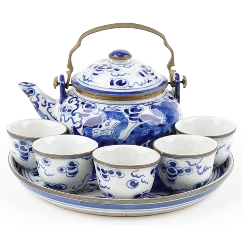 1167A - A Chinese blue and white porcelain teapot with six cups and circular tray hand painted with qilins, ... 