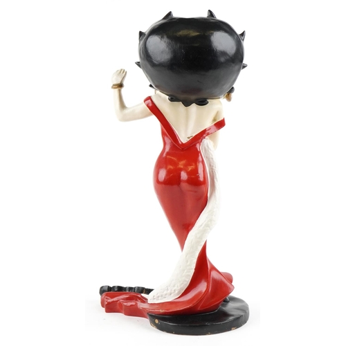 462 - A vintage resin and hand painted model of Betty Boop wearing a red dress and white scarf, 53cm high.