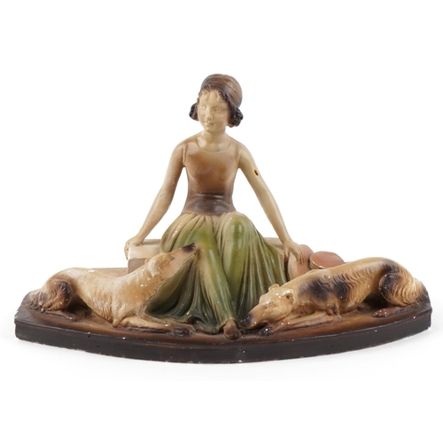 7 - A French Art Deco pottery study of a female with two hounds, 41cm wide.