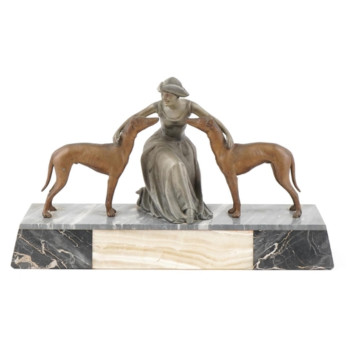  An Art Deco spelter figure of a female with two Greyhounds raised on a black slate and onyx base, 46... 