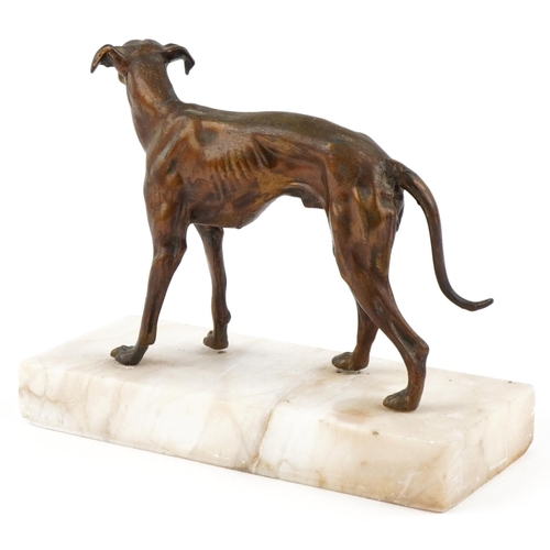 4 - A bronzed spelter study of a Greyhound raised on an onyx base, 28.5cm in length.