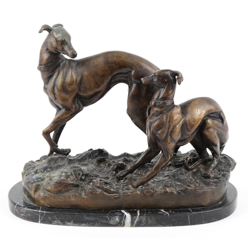 3 - A 20th century bronzed study of two Greyhounds raised on a black marble base, 33cm in length.