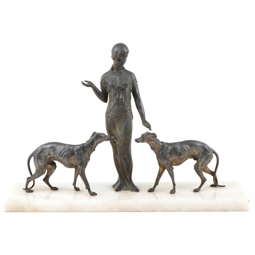  A French Art Deco silver plated study of a female standing with two Greyhounds raised on an onyx bas... 