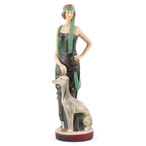 1158 - A large Art Deco style study of a female standing with a Greyhound, 64.5cm high.