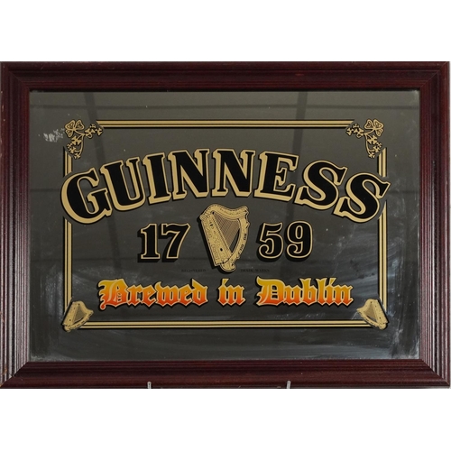 2325E - A Guinness 1759 Brewed in Dublin advertising mirror with stained wood frame, 69cm x 54cm.