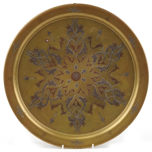 1162 - Islamic Cairoware brass tray with copper and silver foliate inlay, 39.5cm in diameter