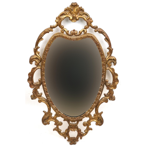 2048 - A late 20th century gilt framed oval wall mirror, 63cm x 41cm, together with a Rococo style gilt ova... 