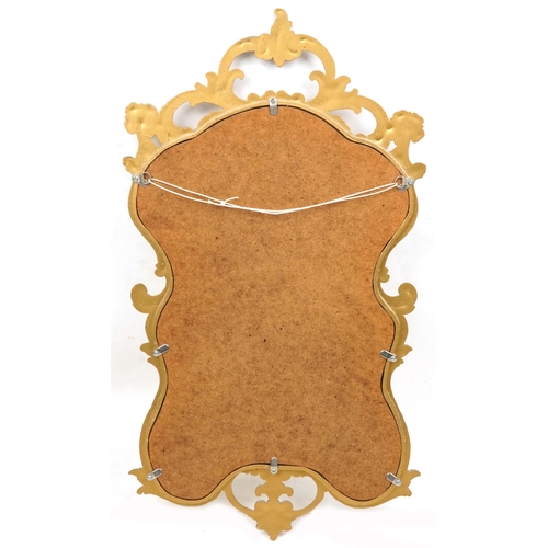 2116 - A late 20th century gilt framed scrollwork wall mirror, 70cm x 38cm.